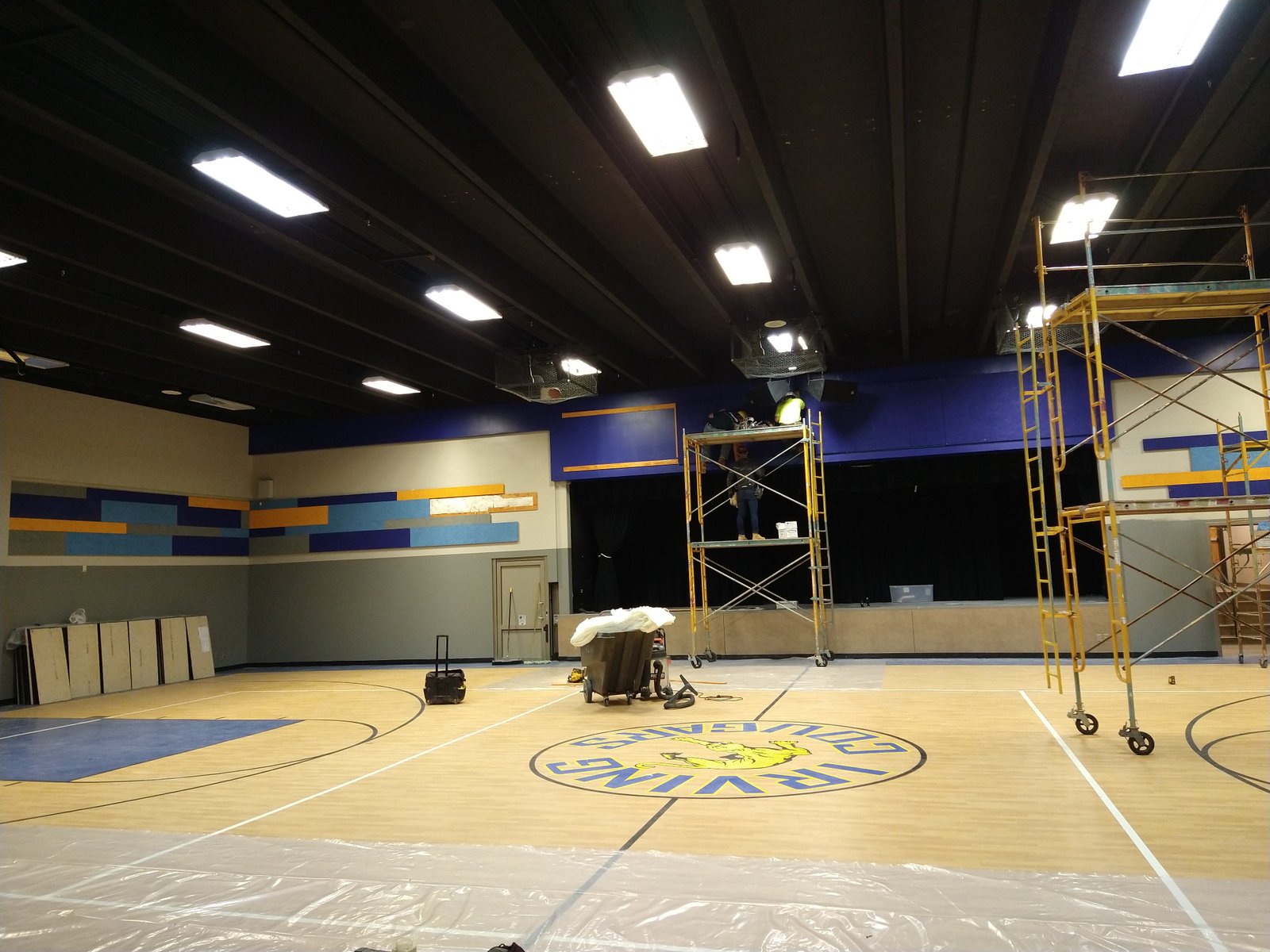 Contractor measuring and cutting drywall panels