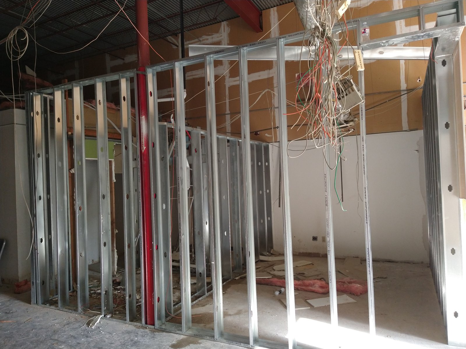 Team installing metal framing for interior room division